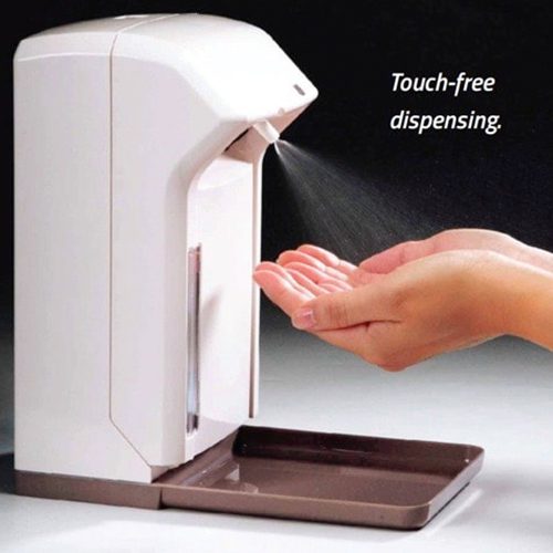 A hand sanitizer dispenser with a person holding it.