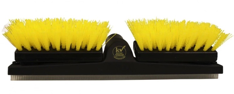 A yellow brush is on the side of a black holder.