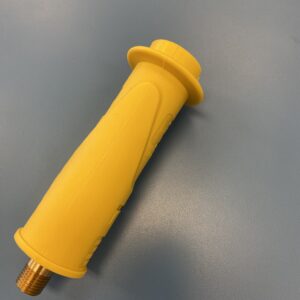 A yellow handle on top of a table.